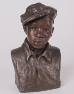 A painted plaster bust of a young boy, made by August Savage